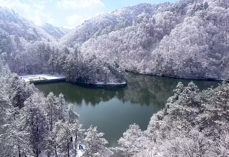 10 ที่เที่ยวหนานหนิง เสน่ห์เมืองสีเขียวแดนมังกร ต้องไปเยือน 8 ทัศนียภาพของทะเลสาบล้อมรอบด้วยป่าสนที่ปกคลุมด้วยหิมะในมณฑลกวางสี
